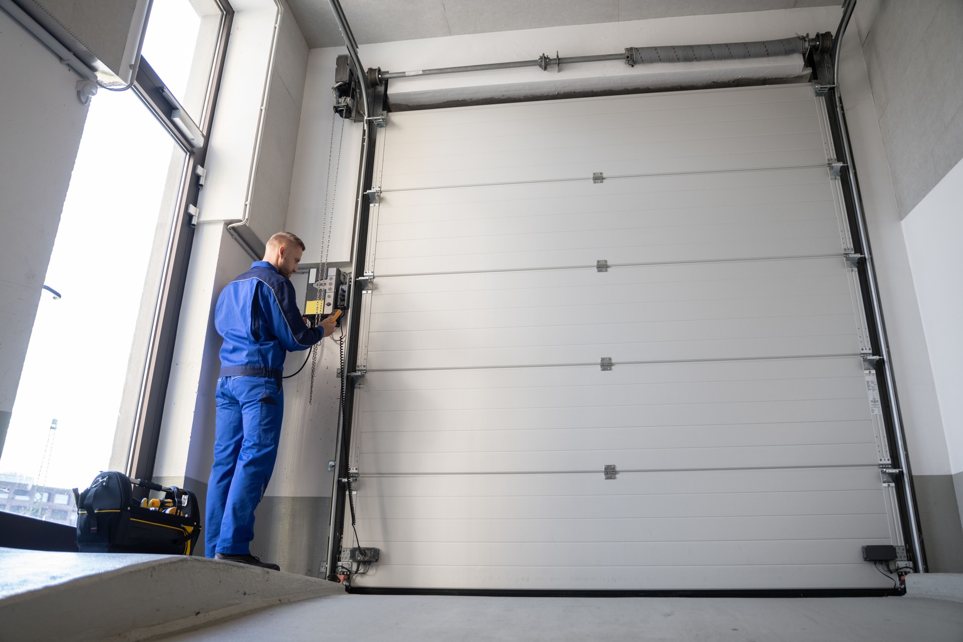 Garage Door Installation And Repair At Home. Contractor Man