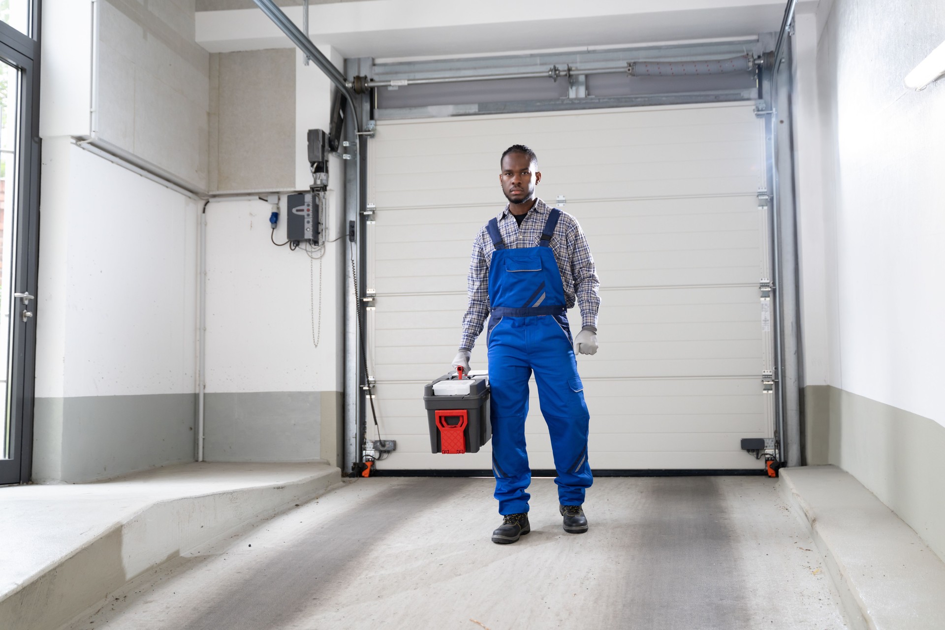 Garage Door Installation And Repair At Home. Contractor Man